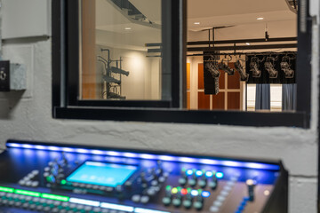 Mixing console, sound board, equipment in an auditorium, theater sound / projection booth.
