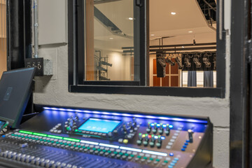 Mixing console, sound board, equipment in an auditorium, theater sound / projection booth.
