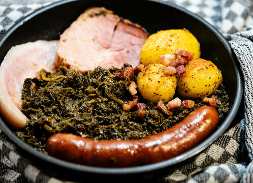 Norddeutsches Nationalgericht Gr&uuml;nkohl mit Schweinebacke Kohlwurst und R&ouml;stkartoffeln