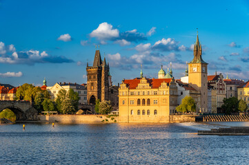 Old Town Bridge Tower (Staroměstsk&aacute; mosteck&aacute; věž) on the Charles bridge end and XIX century waterworks building  over Vltava River in Prague, Czech Republic