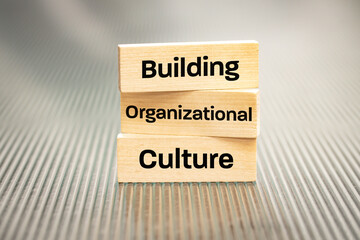 A wooden block with the words Building, Organizational, Culture, Modern approach to working with...