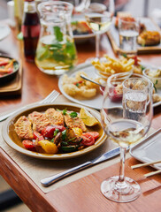 Banquet table, delicious and fresh food: wine, fish, sauce. 