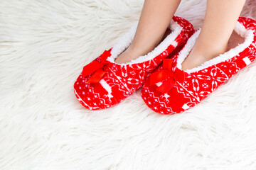 New Year's, Christmas slippers for adults are dressed for the child. On white soft fur. Funny, funny, humorous, cozy,
