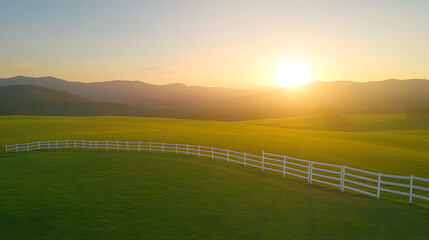 Fototapeta premium White Fence on a Green Farm | Serene Countryside Landscape with Lush Green Fields | Picturesque Rural Farm with Rustic Charm and Natural Beauty