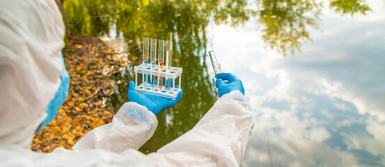 Take water samples for analysis. Selective focus.