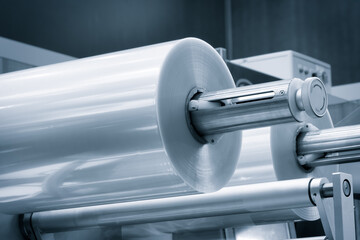 Automatic polyethylene plastic bag production machine with lighting effect. Close-up of the roller...