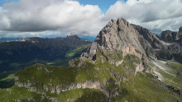 Aerial view of Seceda ridge in the Italian Dolomites, featuring its iconic high altitude meadow and breathtaking alpine scenery under summer sky
