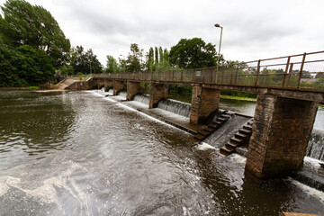 Water flowing over a weir bridge