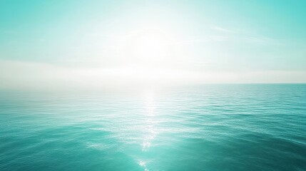 Obraz premium A calm blue ocean with a sun shining on the water
