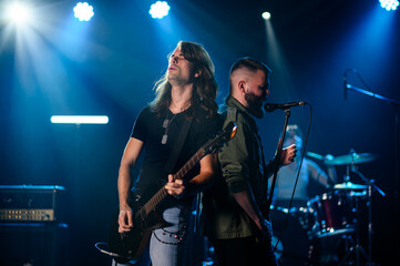 Rock band performing live on stage with passion