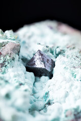 Cuprite on chrysocolla macro photography. Specimen from Mashamba West Mine, Kolwezi, Lualaba, Dr Congo. detail texture background. close-up raw rough unpolished semi-precious gem