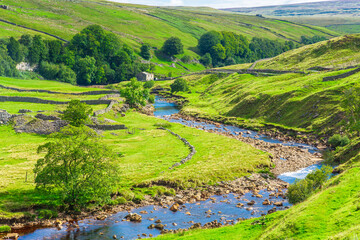 Swaledale in the Yorkshire Dales, UK and the River Swale running through the tiny hamlet of Keld...