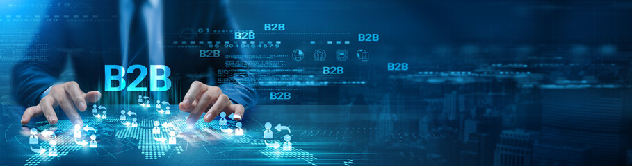 B2B. A futuristic digital interface with a focus on the word 'B2B.' Hands are interacting with...