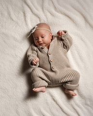 Active European baby full height, one month, pastel colors.