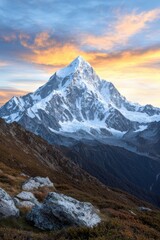 Obraz premium Majestic snow-capped mountain peak at sunset