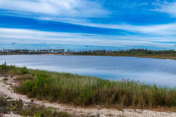 lake stretches into the distance, framed by a wooden structure in the foreground that provides a unique perspective