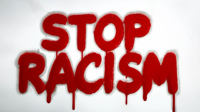 The word stop is written in red spray paint on a white background. This message is meant to convey a strong anti-racism stance