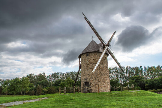 Old stone windmill in the town of Gouville-sur-mer in Normandy, France