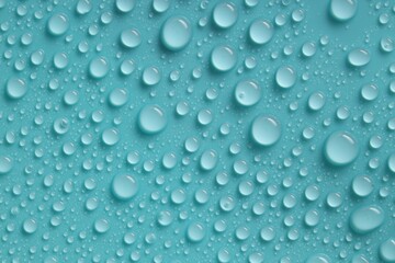 Water drops on turquoise background, above view