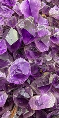 Fototapeta premium Vibrant display of amethyst crystals showcases various shapes and sizes under natural light in a mineral market