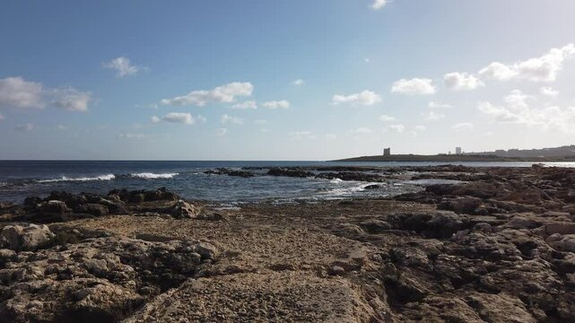 Rocky coast of Malta and Ghallis Tower, Salina small watch tower in the back. Second of De redis Towers. High quality 4k footage