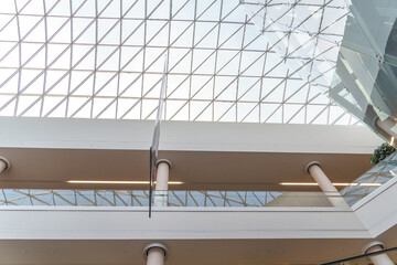 The glass ceiling in the mall from the inside. The interior of the shopping center. modern texture