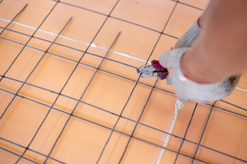 Installation of underfloor heating. Reinforcement welded mesh laid on polyurethane with sealed seams