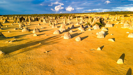 Breathtaking aerial shot of the Pinnacles Desert with golden hues at sunset, Western Australia