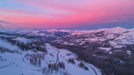 Fototapeta premium During sunset, a snowy road surrounded by trees appears to glow in the winter forest
