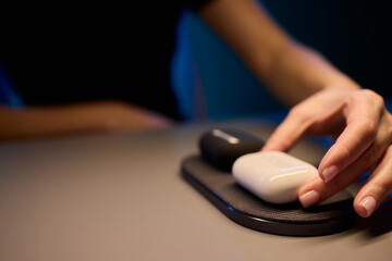Experience the convenience of wireless charging for your earbuds on a sleek modern charging pad