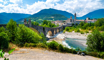 Old bridge Ponte Vecchio, also known as Ponte Gobbo or  Devil's Bridge, at Gobbio, Emilia-Romagna,...