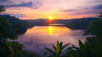 A breathtaking sunset over a serene lake, showcasing vibrant colors reflected in the calm water, framed by rich greenery and lush vegetation.