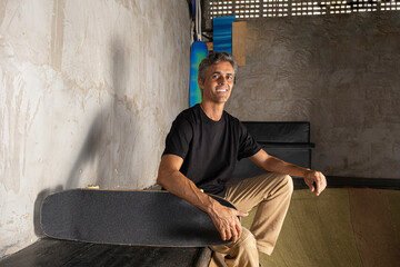 54 year old Brazilian skateboarder in a photo shoot at a skate park_7.