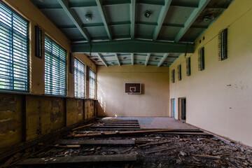 Dark creepy ruined gymnasium in abandoned school