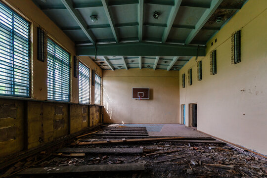Dark creepy ruined gymnasium in abandoned school