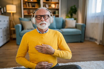 Mature senior man practice guided meditation manifestation at home