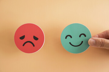 Hand choosing happy smile face, good feedback rating and positive customer review, mental health...
