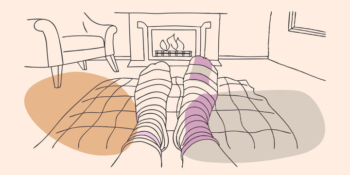 Feet comfortably enveloped in cushy wool socks propped up on an otoman as glow from a burning fireplace reflects off a cozy tartan blanket.