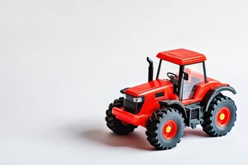 Obraz premium Vivid crimson toy tractor on a white backdrop front view of the upper section