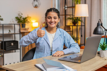 Like. Happy excited Indian woman looking approvingly at camera showing thumbs up like sign positive...