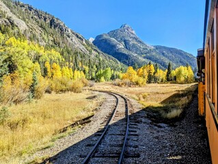 Fototapeta premium Golden Autumn Landscape Along the Silverton Durango Railroad, Colorado Mountains and Train Tracks