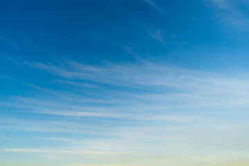 Light Blue Sky with White Pink Clouds Early Evening Sunset. Abstract Texture Background.