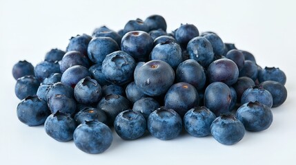 A pile of fresh blueberries spread out on a clean white surface, ready for snacking