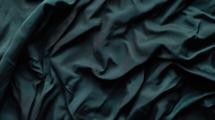 Fototapeta premium Luxurious dark green silk fabric with intricate texture and deep folds, creating an elegant and rich visual background.