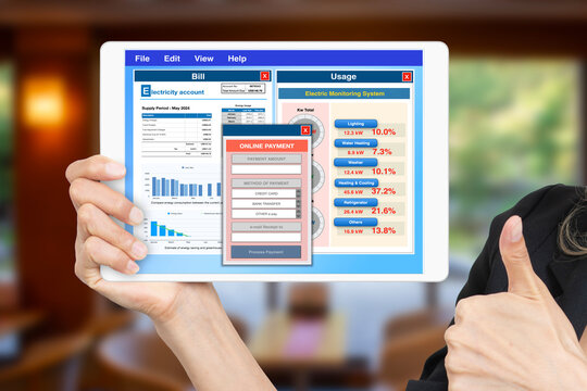 Computer application showing electricity bill and usage with online payment window on digital tablet screen.