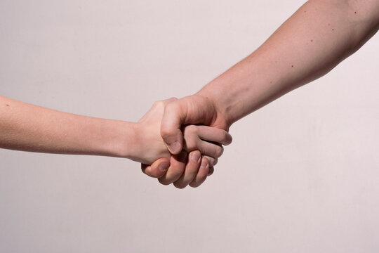 Holding hands. Handshake. Helping hand. Rescue gesture. Support hand. Concept of support. Strong hold. Two hands, helping hand of a friend. Handshake, arms friendship.