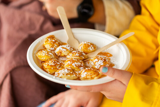 food truck food at event &ndash; plate of mini pancakes with icing sugar and syrup