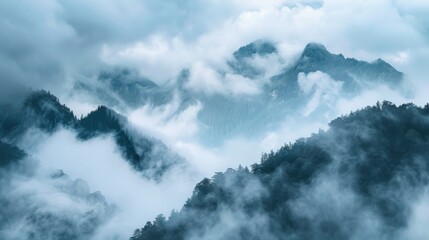 Obraz premium Dense fog and low-lying clouds covering a mountain range, creating a mystical scene
