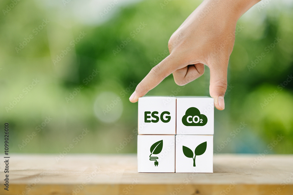 Poster a hand pointing at a stack of four blocks with the letters esg and co2 on them