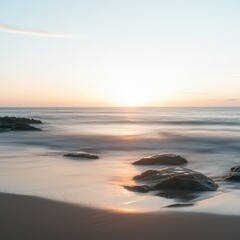 serene sunset over calm ocean waves with smooth sand and rocks